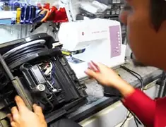 Vacuum repair technician servicing internal components on a workbench in Hollywood, FL