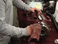 Vacuum repair technician cleaning and servicing a vacuum motor in Hollywood, FL