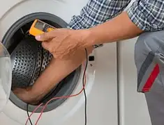 Washing machine repair technician testing a front-load washer with diagnostic tools in Hollywood, FL