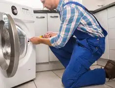 Washing machine repair technician servicing a front-load washer in Hollywood, FL